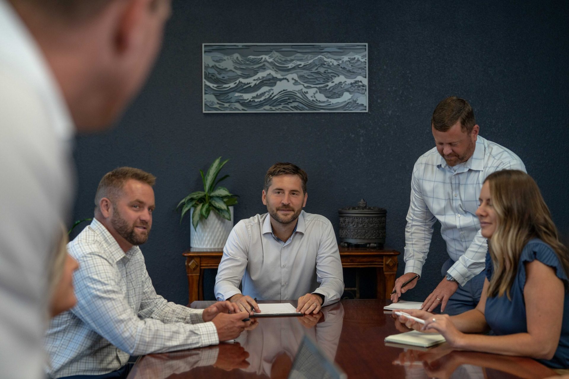 The Rowland Sullivan team meeting around a conference table in their Lake of the Ozarks Office.